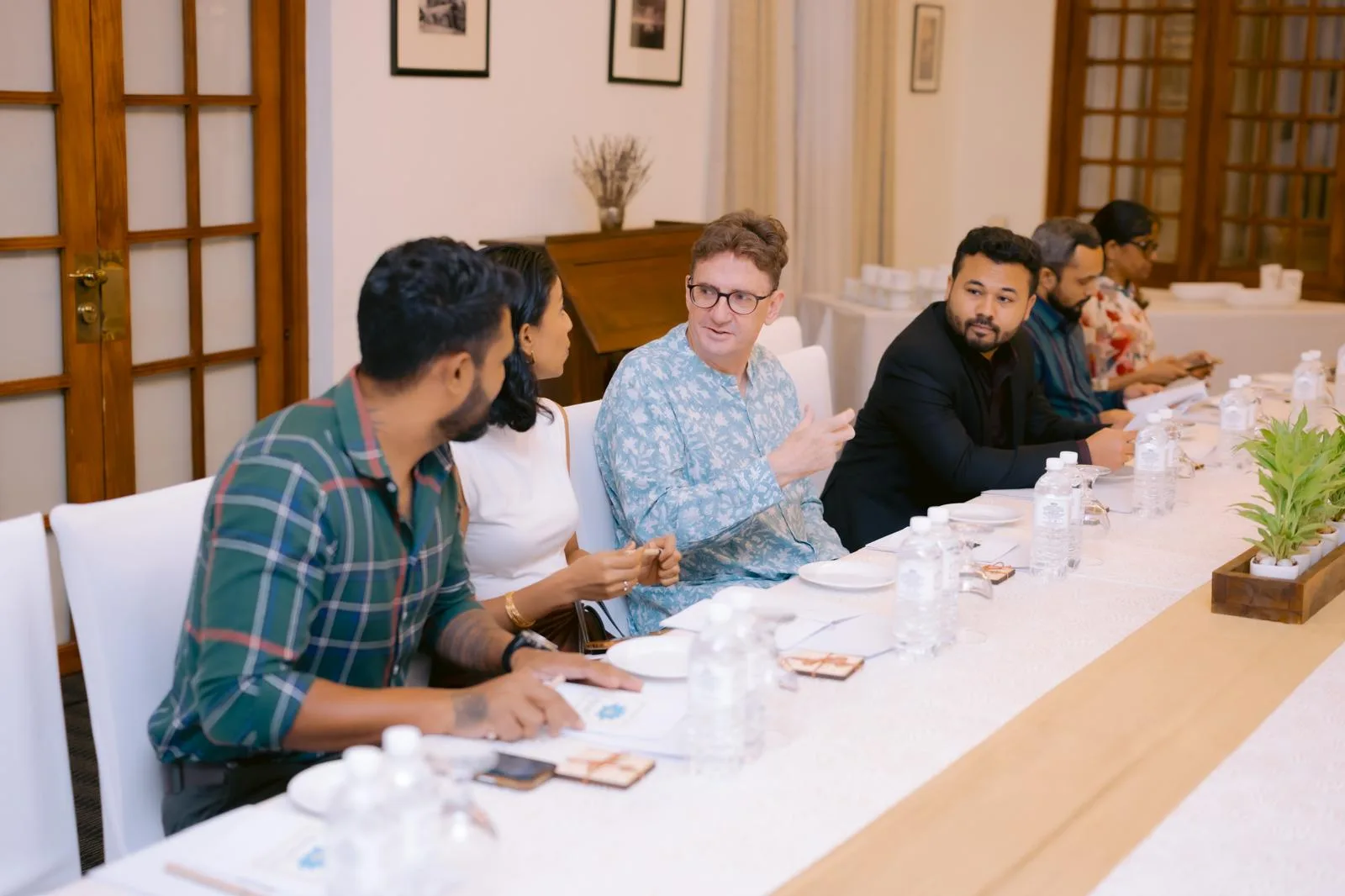 Tasters seated around the long table at the Library Hall